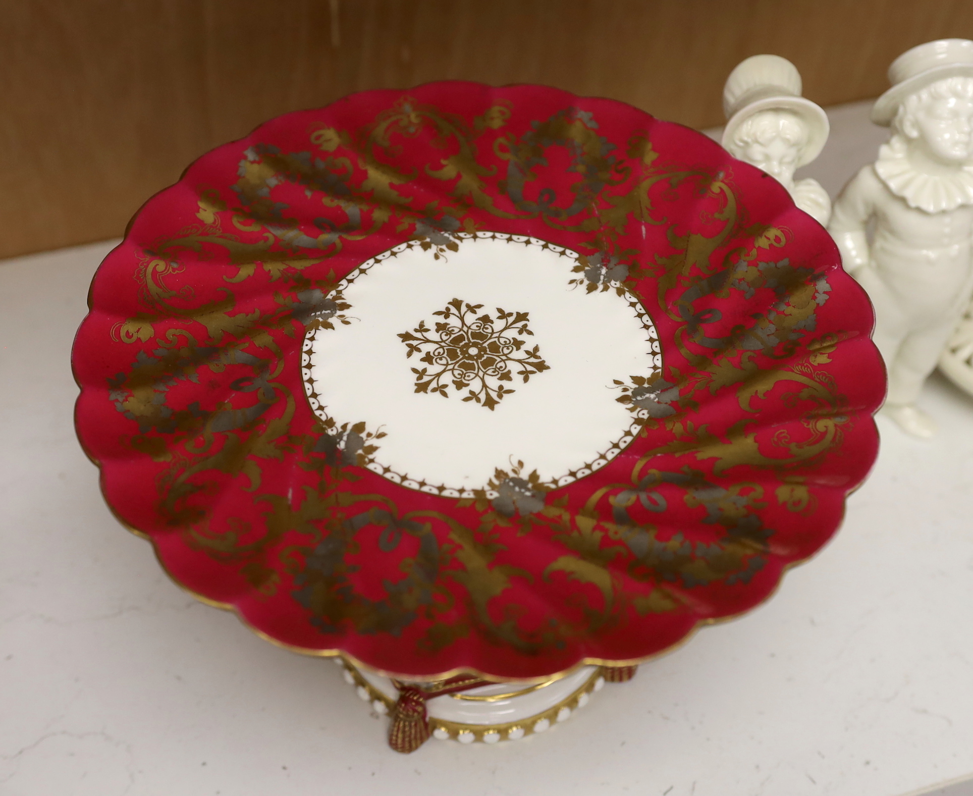 A pair of Royal Worcester figural sugar casters, a pot pourri and a Staffordshire putti comport, the largest 23.5cm in diameter